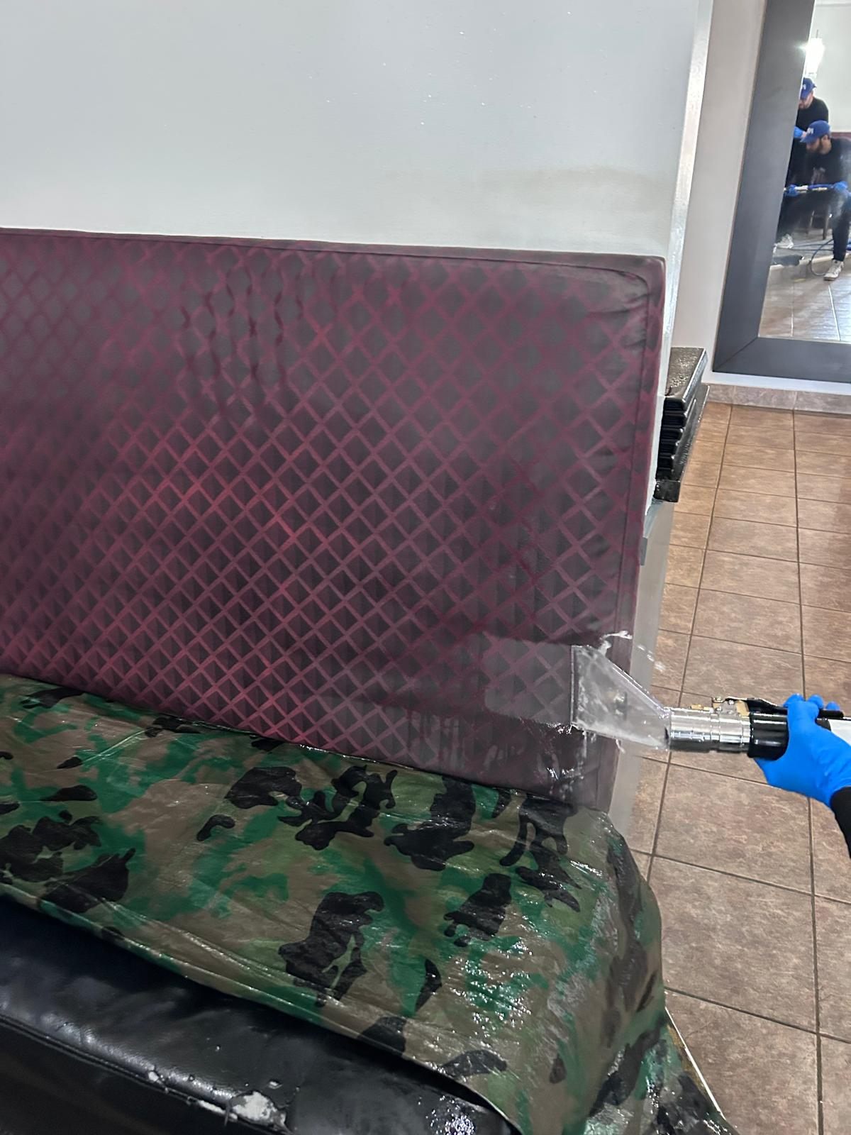 Restaurant booth seating being cleaned with extraction equipment